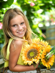 smiling little girl with sunflower