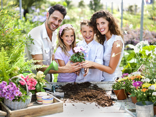 family have fun in the work  of gardening