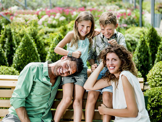family having fun in a greenhouse