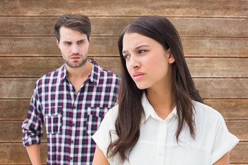 Naklejka premium Composite image of angry brunette not listening to her boyfriend