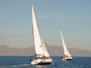 Fototapeta na wymiar two yachts under sail reaching each other
