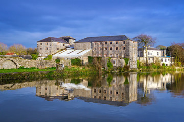 Fototapeta na wymiar Irish stone architecture with reflection in the river, Askeaton
