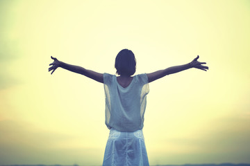 beautifull woman taking a deep breath at the sunset