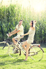 Obraz premium Couple having a bicycles ride into the nature