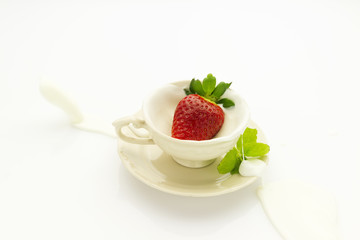 strawberry falling into cream