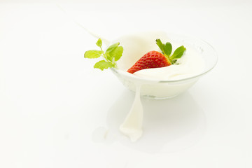 strawberry falling into cream