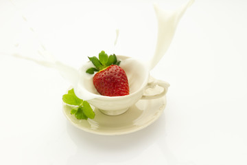 strawberry falling into cream