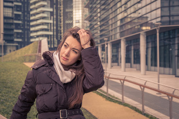 Fototapeta premium Young beautiful girl posing in the city streets