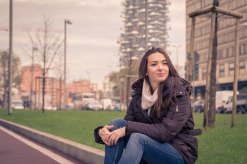 Young beautiful girl posing in the city streets