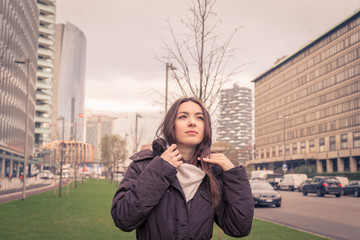 Fototapeta premium Young beautiful girl posing in the city streets