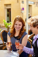 Beautiful couple drinking rose wine