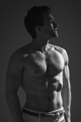 Fototapeta premium Strong athletic man on dark background