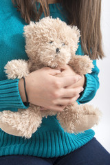 Girl holding teddybear, closeup