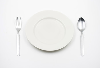 Concept of Empty plate with spoon and fork on a white background