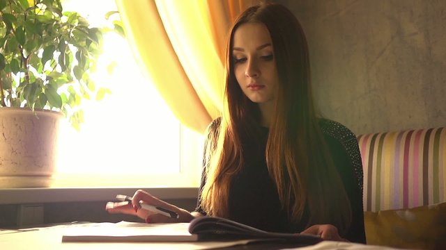 female student preparing for the exam reading