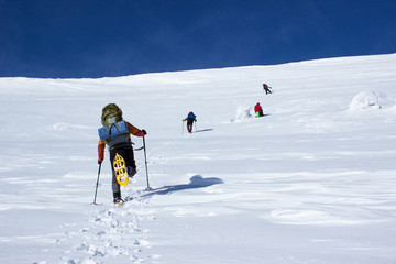 Winter hiking in the mountains on snowshoes .