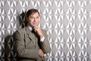 Business man standing near the wall - stock photo