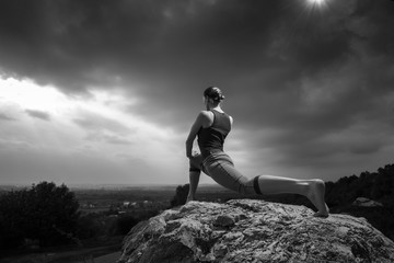 Woman doing yoga against the setting sun