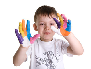 Portrait of happy little boy with paints on hands.