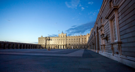 Fototapeta premium Royal palace with tourists illuminated on spring night in Madrid