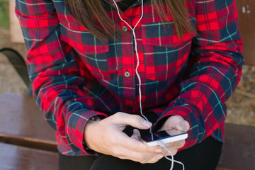 Closeup hands of girl listening to music