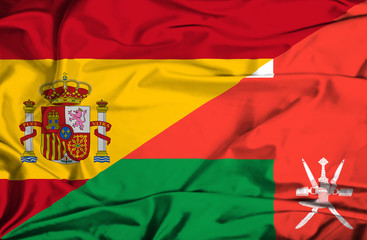Waving flag of Oman and Spain