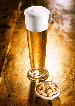 Tall Elegant Glass Of Beer With Nuts