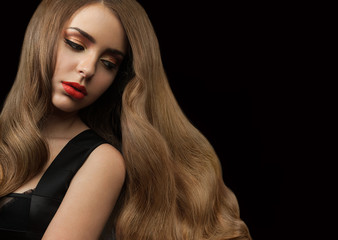 Woman with long shiny hair on a black background.