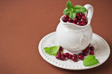 cranberries in a small vintage jug
