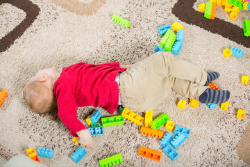 Boy playing with blocks on the floor