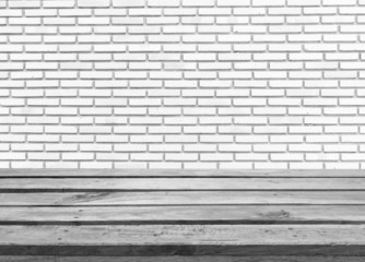 Empty wooden deck table on white brick wall background