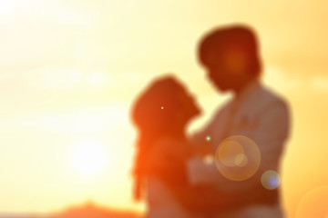 blurred background of couple love at sunset.
