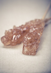 Candy brown and white sugar on a sticks on wooden background