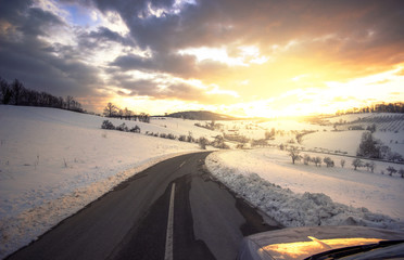 Fototapeta na wymiar Beautiful sunset in january with a road ahead
