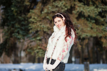 Outdoor fashion portrait of young woman in cold winter weather