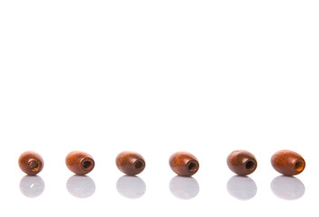 Brown round wooden beads over white background