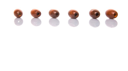 Brown round wooden beads over white background