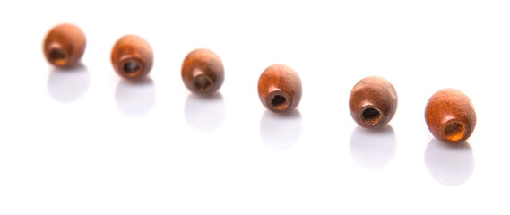 Brown round wooden beads over white background