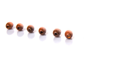 Brown round wooden beads over white background