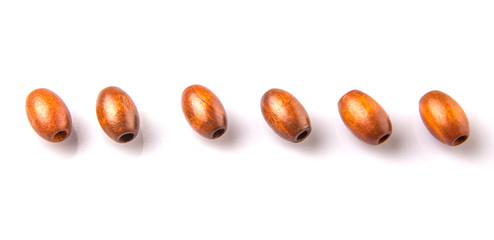 Brown round wooden beads over white background