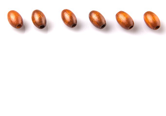 Brown round wooden beads over white background