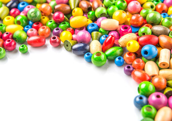 Colorful wooden beads on white background