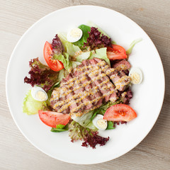 Fresh beef salad with lettuce, tomatoes, boiled eggs, mustard sa