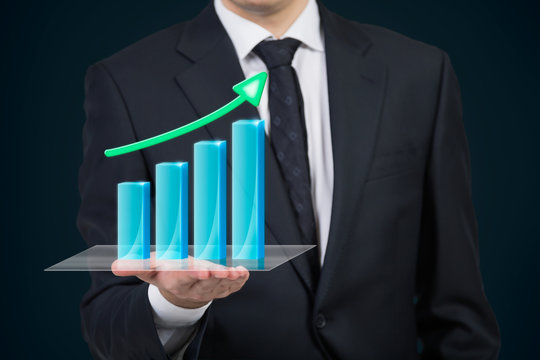 businessman holding stock graph