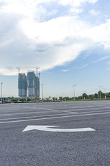 Empty parking lot with construction background