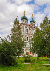 Fototapeta na wymiar Vvedenskaya church in Solvychegodsk behind the trees