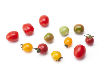 Colorful tomatoes on background