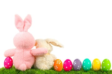 Hugging Easter bunnies on grass with colorful egg border