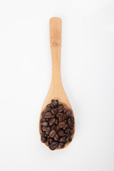 Roasted coffee beans with wooden spoon