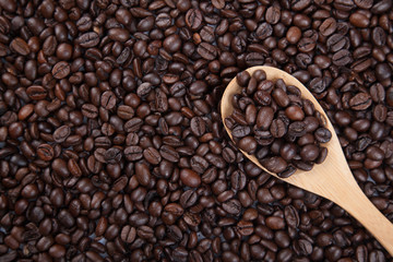 Roasted coffee beans with wooden spoon